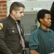 Acussed sniper John Lee Malvo is escorted by a Fairfax County Sherriff as he leaves the Fairfax County Juvenile Court House Nov. 19, 2002, in Fairfax, Va.